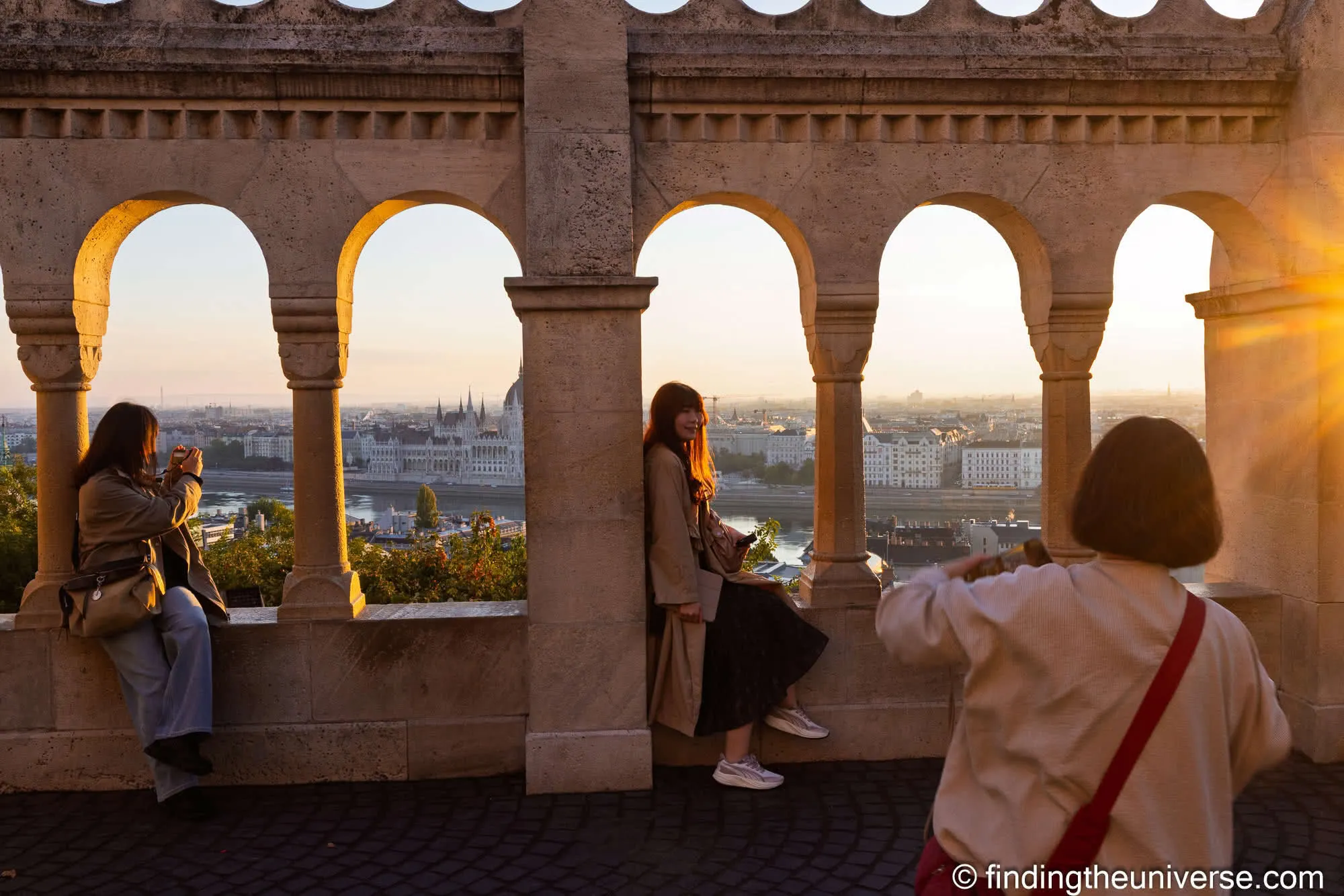 Hungarian Parliament through the arches of Fisherman's Bastion at sunrise