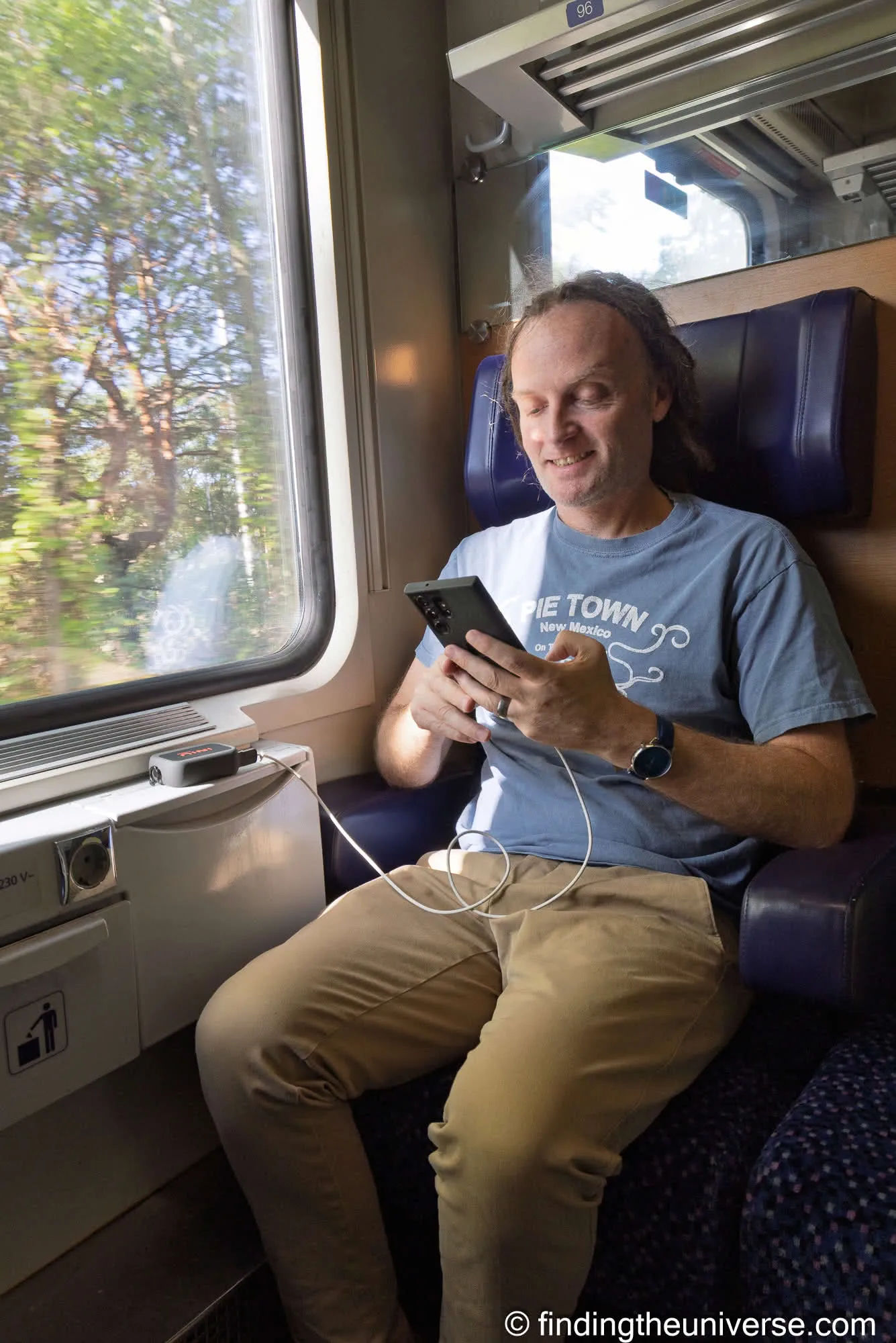 Laurence charging his phone from the INIU RG-10000 on a train in Bratislava, Slovakia