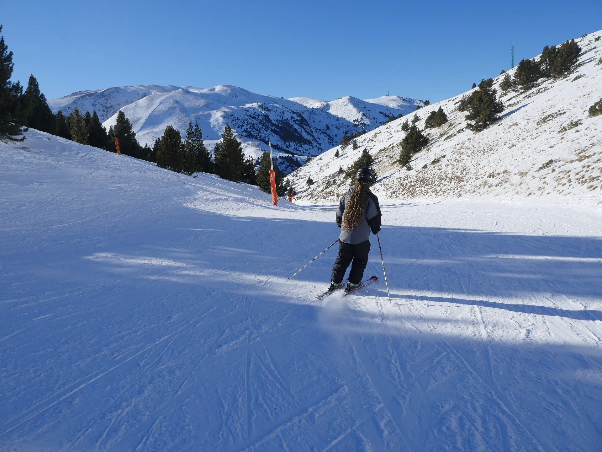 Skier on a bright sunlit piste in the Spanish Pyrenees